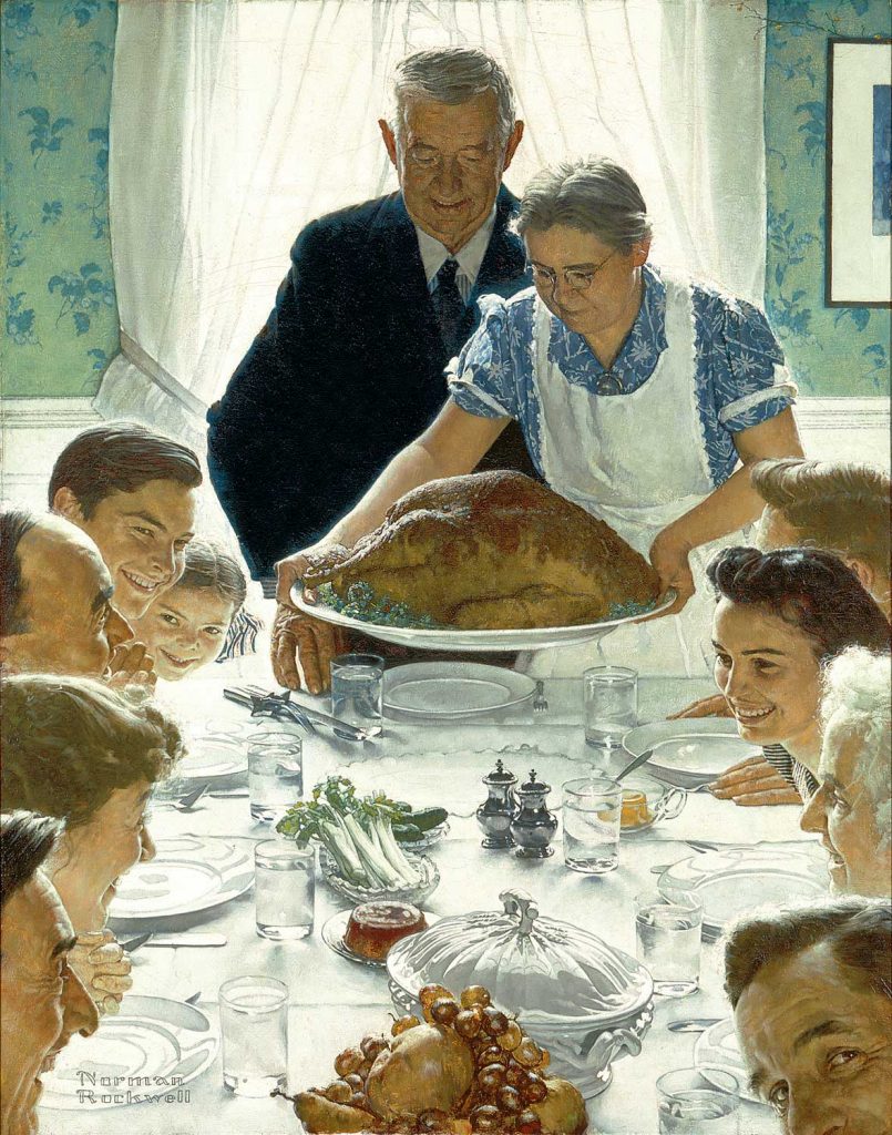 Family serving turkey at thanksgiving