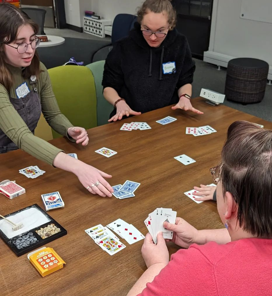 Students playing cards at the table in the Center